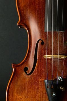 an old violin with strings hanging from it's back