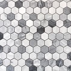 an image of a white and black marble tile pattern that looks like hexagonal tiles