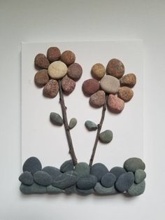 some rocks are arranged on top of each other to make a flower arrangement in the shape of stones