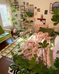 a living room filled with furniture and lots of green plants in the middle of it