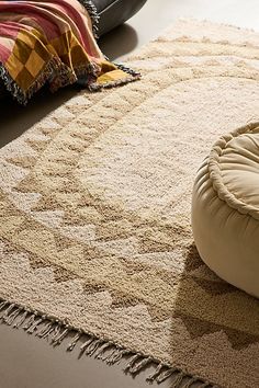 a round dog bed sitting on top of a rug