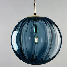 a blue glass light fixture hanging from a ceiling