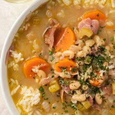 a white bowl filled with soup and rice