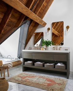 a bathroom with two sinks and mirrors in the ceiling above it is an area rug