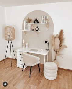 a white desk and chair in a room with wood flooring, shelves on the wall