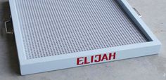 an empty white tray with the word ejjah on it and red lettering