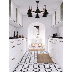 a kitchen with black and white tile flooring and pendant lights hanging from the ceiling