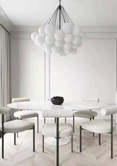 a white dining room table surrounded by chairs