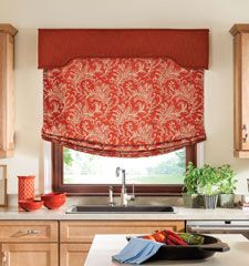 a kitchen with an orange roman blind in the window and some fruit on the counter