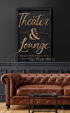 a brown leather couch in front of a black wall with the words theater and lounge on it