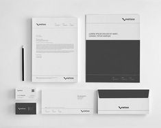 the stationery is laid out neatly on top of each other, including business cards and envelopes