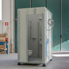 a portable toilet in the middle of a warehouse