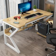 a computer desk with a monitor, keyboard and mouse on top of it in front of a window