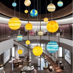 a spiral staircase with planets hanging from the ceiling