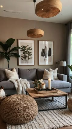 a living room filled with lots of furniture next to a large window and potted plants