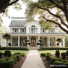 a large white house with lots of trees and bushes in front of it that says charleston