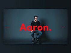 a man sitting on top of a chair with the word aaron in front of him