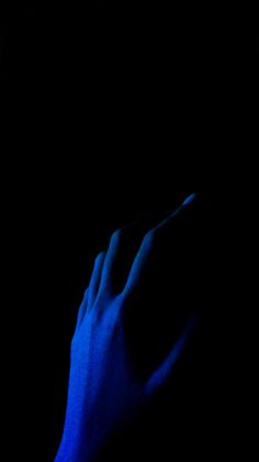 a person's hand on a cell phone in the dark