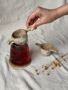 a person is spooning something out of a jar