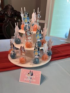 an assortment of cupcakes on a cake stand at a birthday party or baby shower