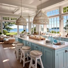 a kitchen filled with lots of counter top space next to an open floor plan and large windows