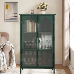 a green cabinet with glass doors in a living room