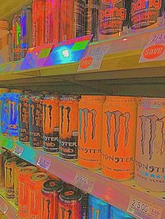 several cans of monster energy drink are on display in a grocery store's cooler