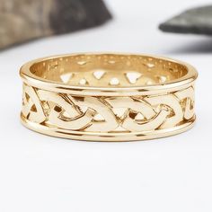 a gold ring with an intricate design on it