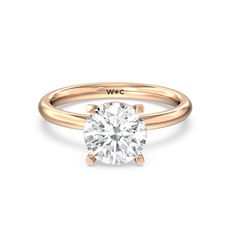 a rose gold engagement ring with a round diamond