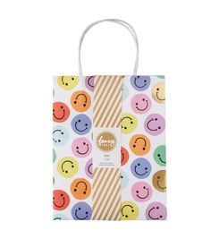 a small shopping bag with smiley faces on the front and bottom, in multicolored circles