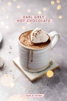 a cup of hot chocolate with whipped cream on top and the words, ear grey hot chocolate