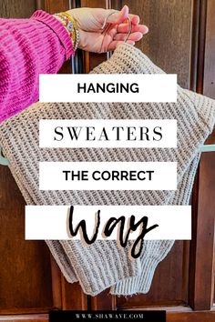 a woman's hand holding onto a sweater that is hanging on a door with the words hanging sweaters the correct way