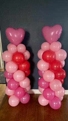 two tall pink and red balloons in the shape of hearts