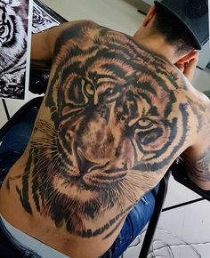 a man with a tiger tattoo on his back