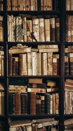 an old bookshelf filled with lots of different types of books on top of each other