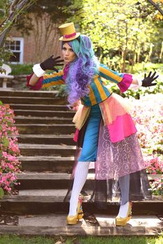 a woman dressed in costume standing on some steps with her arms out to the side