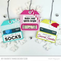 three tags hanging from strings with snowflakes around them and saying, make your spirits bright