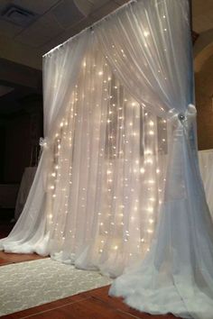 a white curtain with lights hanging from it