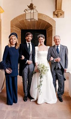 the bride and groom are posing with their parents