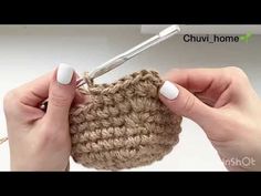 someone is crocheting the bottom part of a small bag with a crochet hook