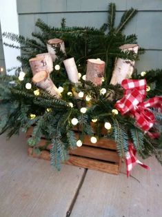 a wooden crate filled with christmas trees and candles