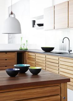 three bowls are sitting on a table in the kitchen