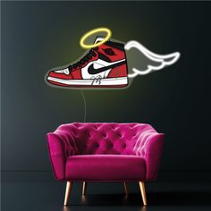 a red and white sneaker with an angel wing on it's shoe is flying through the air