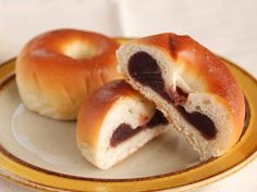 two chocolate filled bagels on a plate