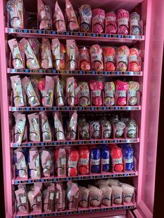 a pink refrigerator filled with lots of candy