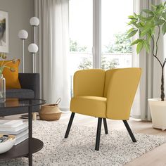 a modern living room with yellow chairs and white rugs in front of the window