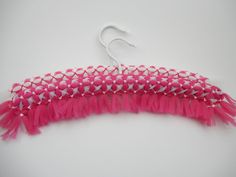 a pair of pink and white fringes hanging from a hook