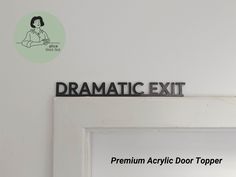 a sign that says dramatic exit on the wall above an open door with a woman's face