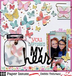 a scrapbook page with butterflies and a jar