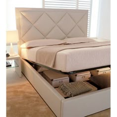 a bed with drawers underneath it in a room